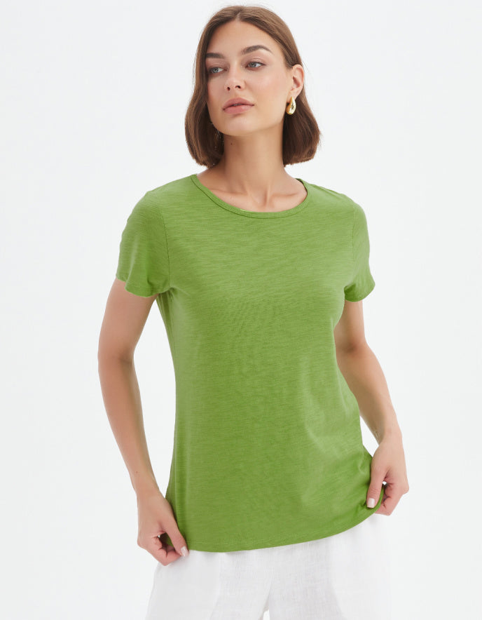Woman wearing a green t-shirt against a white background