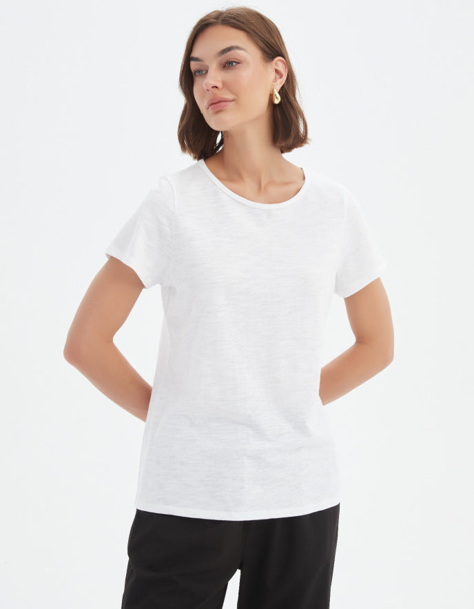 Woman wearing a white t-shirt on a plain background