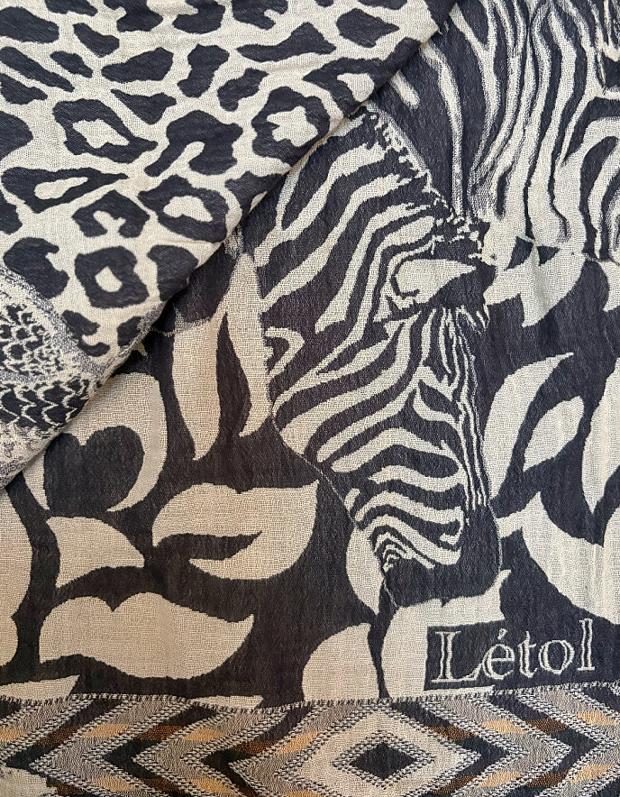 Textile with leopard, zebra, and geometric patterns featuring the brand 'Létol'.