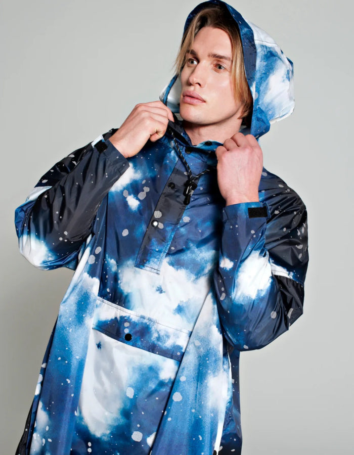 one size waterproof poncho with hood and large kangaroo pocket featuring a starry night print in blue and greys with reflective stars