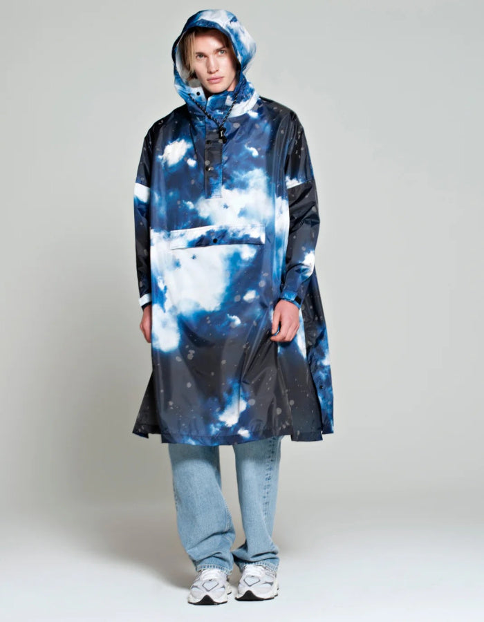 one size waterproof poncho with hood and large kangaroo pocket featuring a starry night print in blue and greys with reflective stars