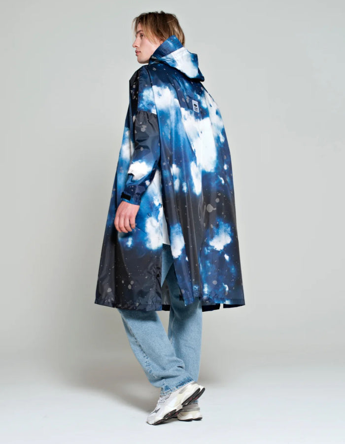 one size waterproof poncho with hood and large kangaroo pocket featuring a starry night print in blue and greys with reflective stars