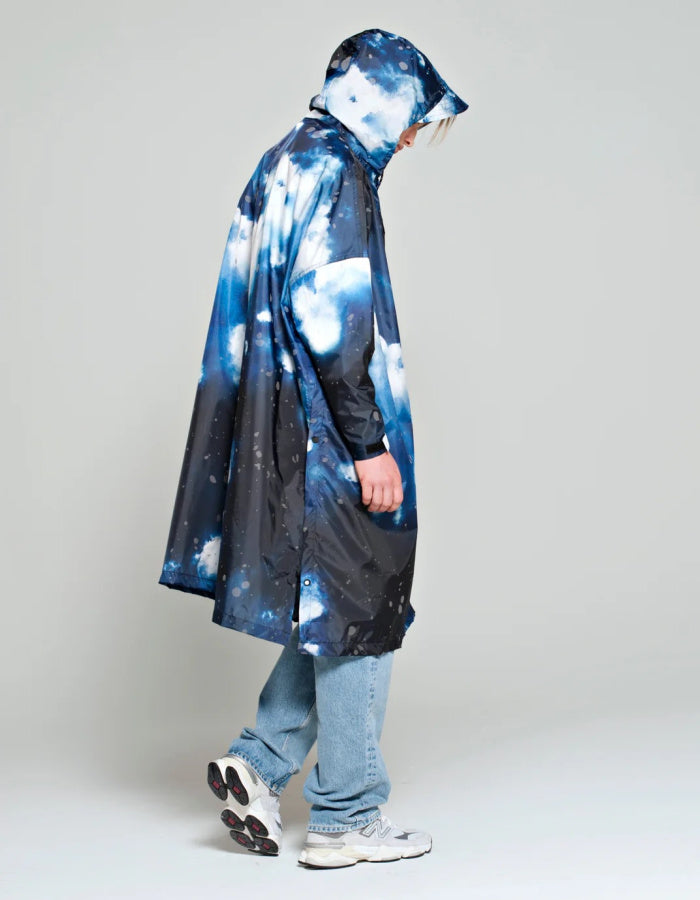 one size waterproof poncho with hood and large kangaroo pocket featuring a starry night print in blue and greys with reflective stars