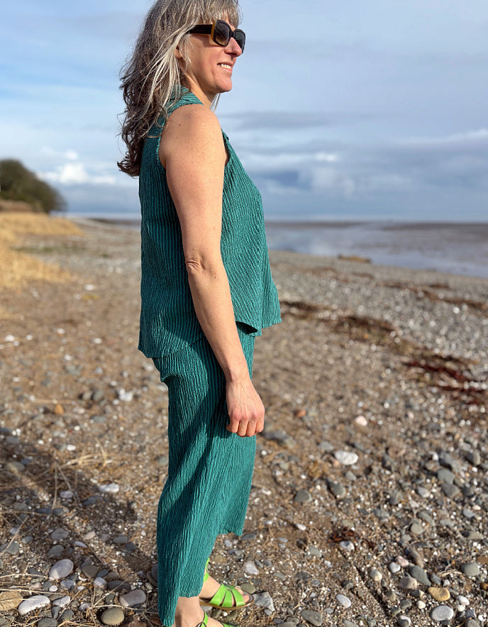 woman wearing teal coord top and trousers in cotton teal