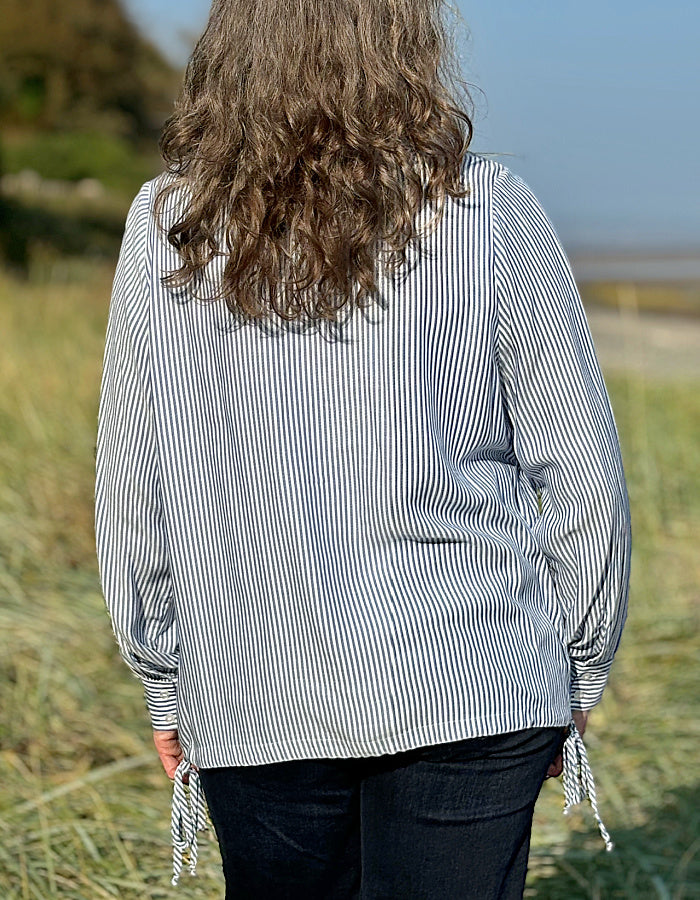 blue and white stripe blouse with half button placket fastening at the front and side drawstring tie