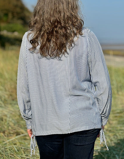 blue and white stripe blouse with half button placket fastening at the front and side drawstring tie