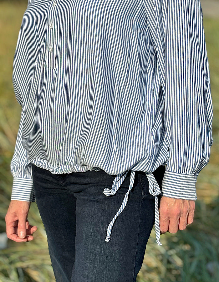 blue and white stripe blouse with half button placket fastening at the front and side drawstring tie