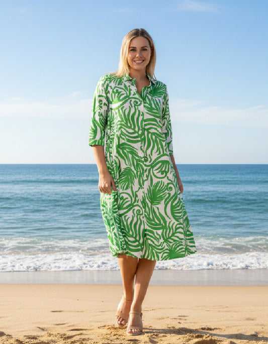 woman wearing green and white shirt dress on a beach