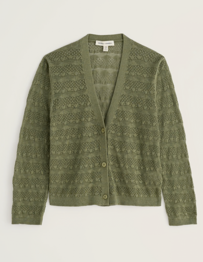 Green patterned cardigan on a light gray background