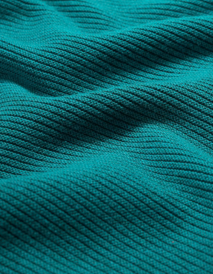 Close-up of teal fabric with a textured pattern