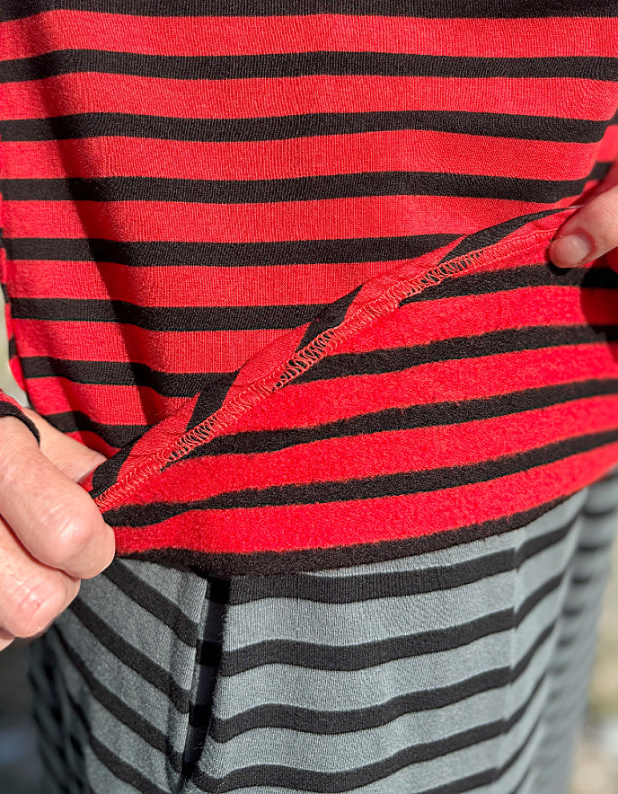 Close-up of a red and black striped garment with fleece lining