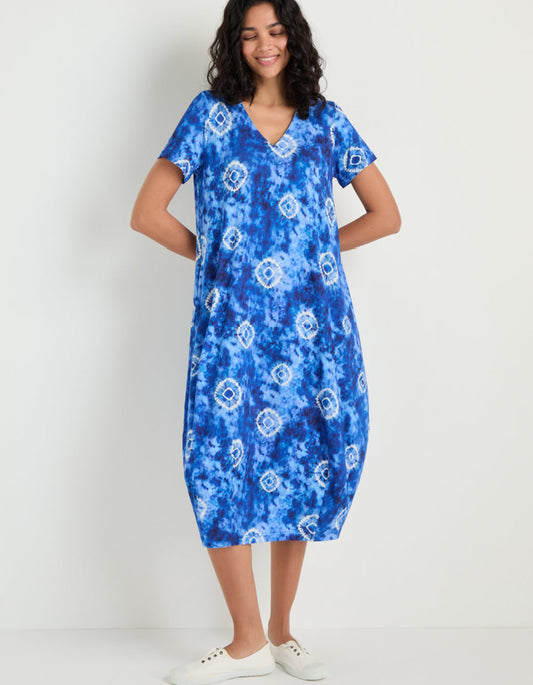 woman wearing a midi length tie dyed blue and white jersey bubble dress