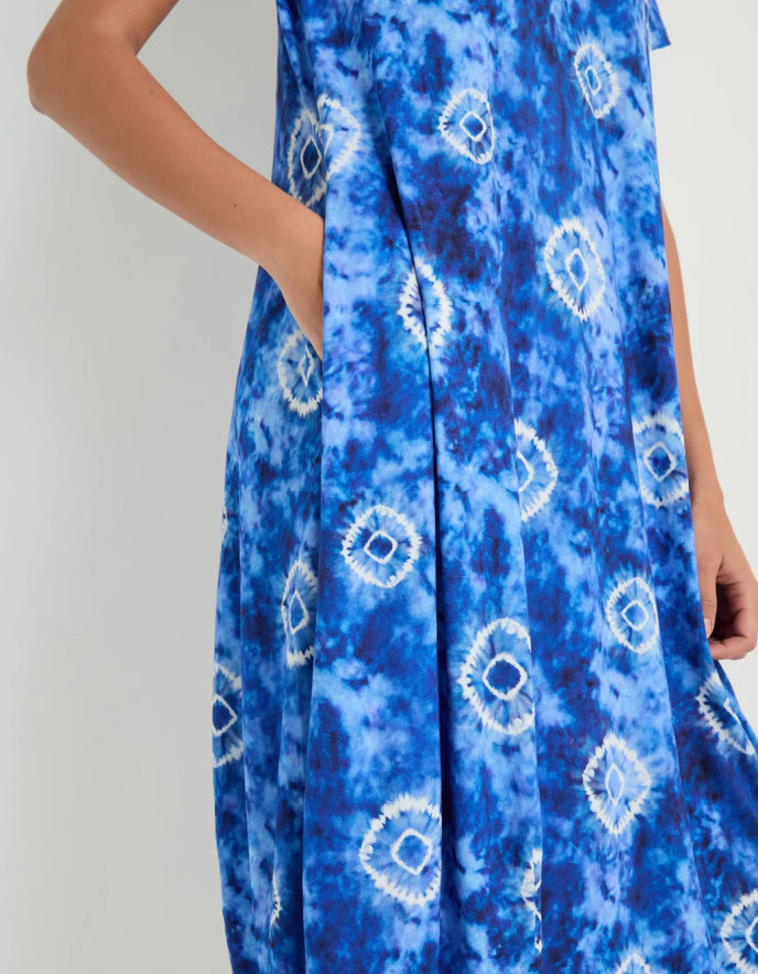 woman wearing a midi length tie dyed blue and white jersey bubble dress