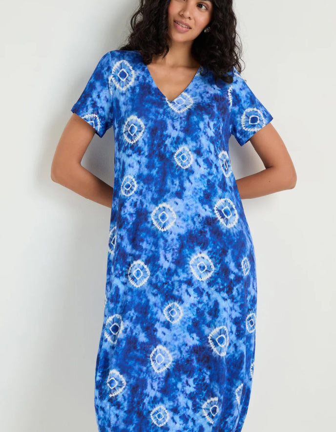 woman wearing a midi length tie dyed blue and white jersey bubble dress