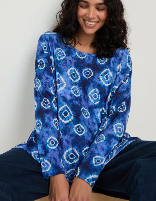 woman wearing tie dye blue and white loose fit jersey top