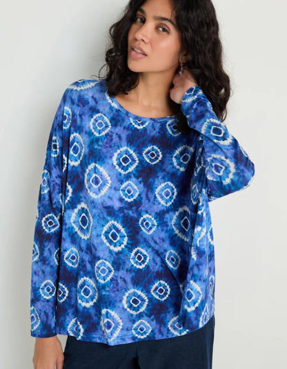 woman wearing tie dye blue and white loose fit jersey top