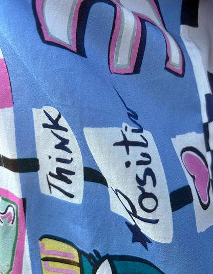 Text 'Think Positive' on a colorful background with abstract designs.