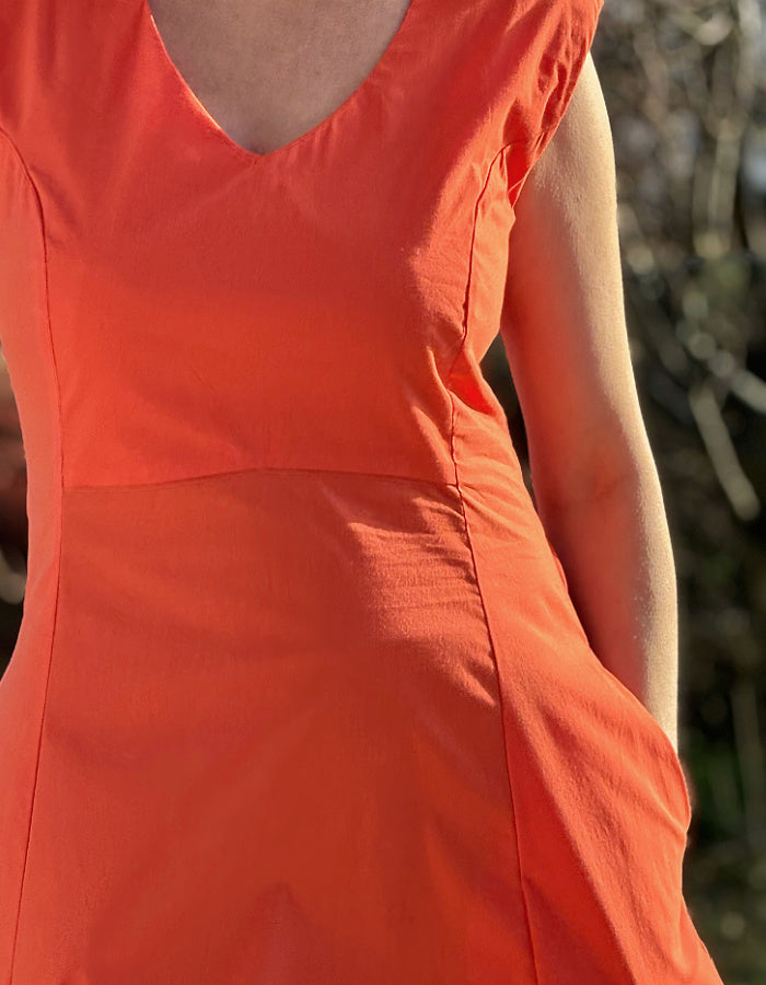 stretchy trapeze midi length bubble dress with v neckline and sleeveless design in stunning coral orange colour