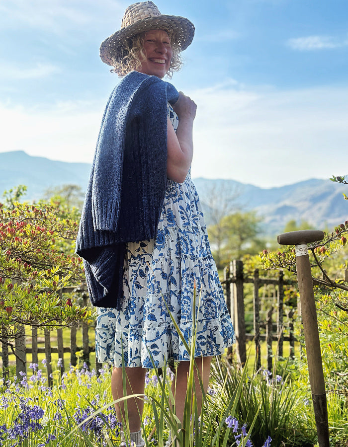 knee length summers day cotton dress with tiered flared skirt in blue and white floral print