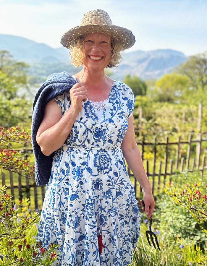 knee length summers day cotton dress with tiered flared skirt in blue and white floral print