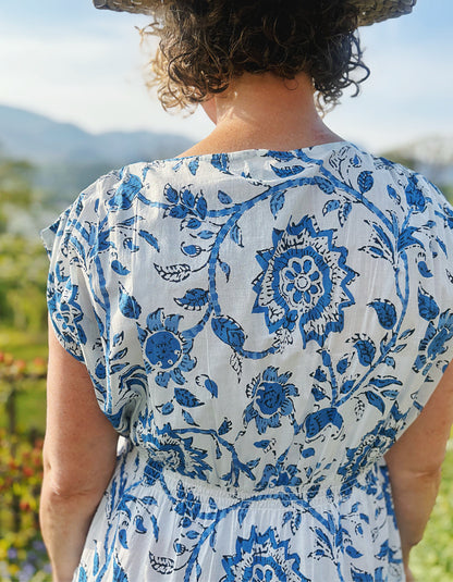 knee length summers day cotton dress with tiered flared skirt in blue and white floral print