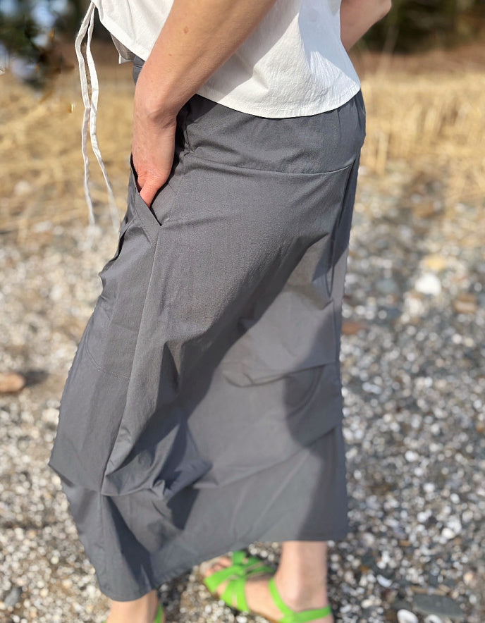 Person wearing gray shorts on a gravel surface