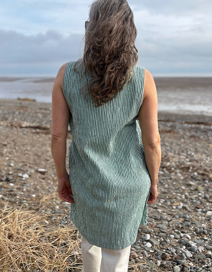 woman wearing mint striped tunic dress with cream jeans