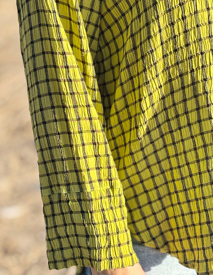 ochre green viscose swing shirt with black check print. box pleat at the back