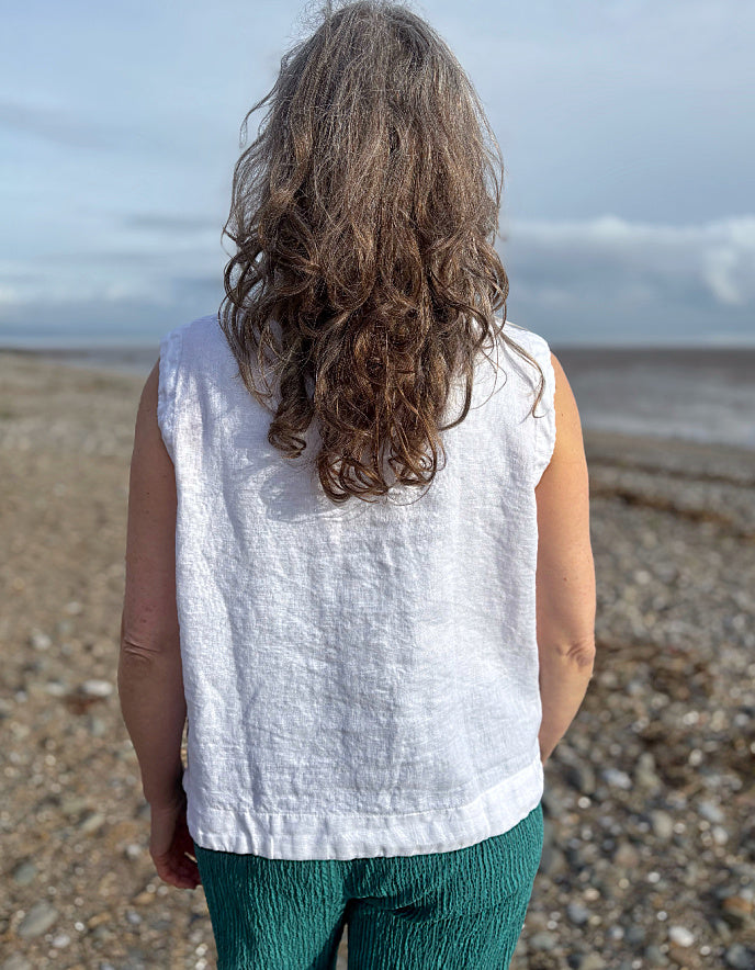 woman wearing white linen waistcoat
