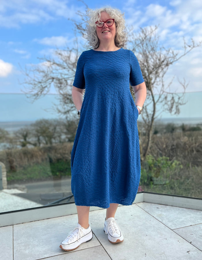 midi length blue jersey bubble dress with short sleeves and waffle texture and pockets