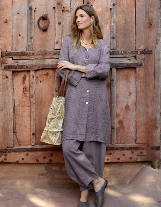 lady wearing mushroom coloured linen textured duster style coat