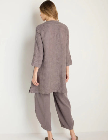 lady wearing mushroom coloured linen textured duster style coat