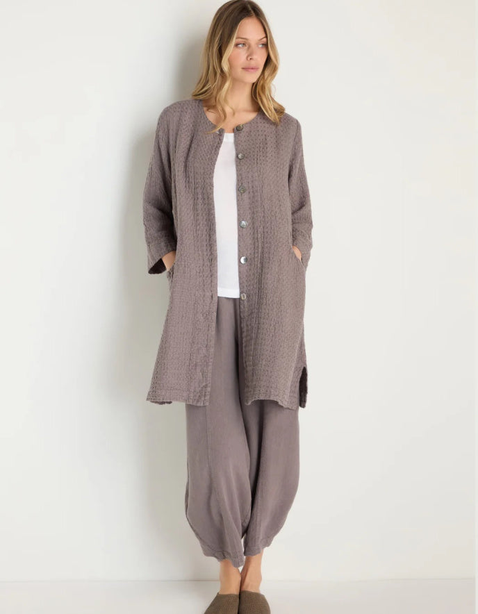 lady wearing mushroom coloured linen textured duster style coat