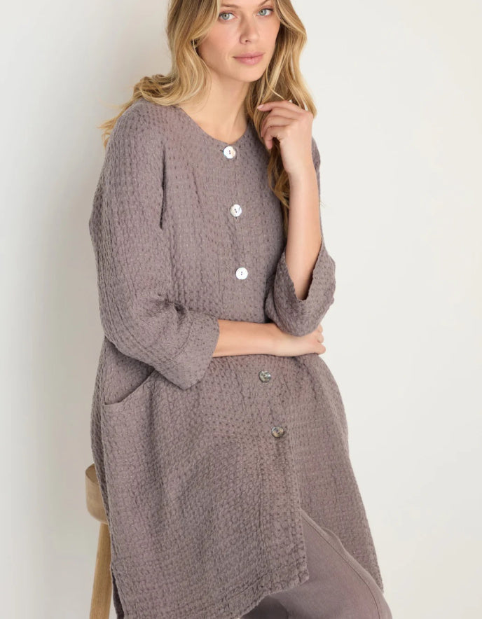 lady wearing mushroom coloured linen textured duster style coat