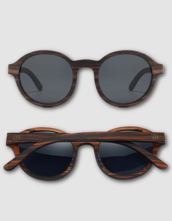 Two views of round sunglasses with a dark brown wood grain frame and dark lenses, shown from the front and side on a light gray background.