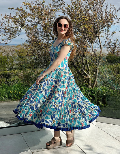 turquoise, blue and red hand block print cotton summer dress with scoop neck and capped sleeves and a full skirt