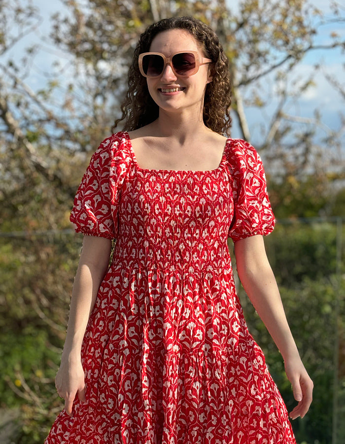 midi length red cotton summer dress with elasticated neckline and cuffs so can be worn on or off the shoulders and smocked bodice