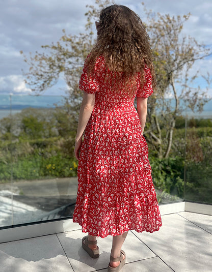 midi length red cotton summer dress with elasticated neckline and cuffs so can be worn on or off the shoulders and smocked bodice