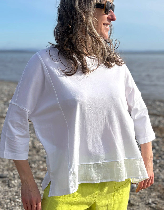 woman wearing oversized white cotton jersey top and citron yellow linen trousers