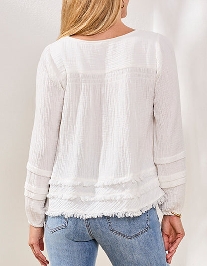 White textured blouse worn by a person with a neutral background