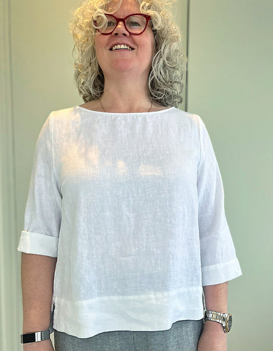 white linen top with elbow length sleeves and side split hemline