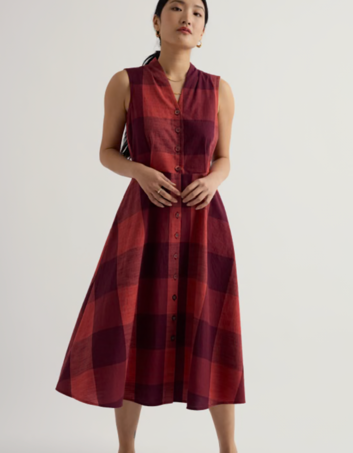 Woman wearing a red plaid dress on a white background