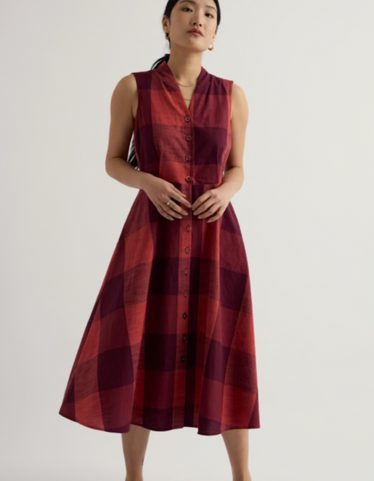 Woman wearing a red plaid dress on a white background