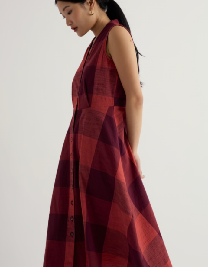 Woman wearing a red plaid dress on a white background