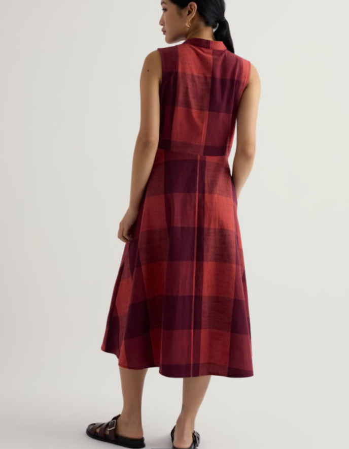 Woman wearing a red plaid dress on a white background