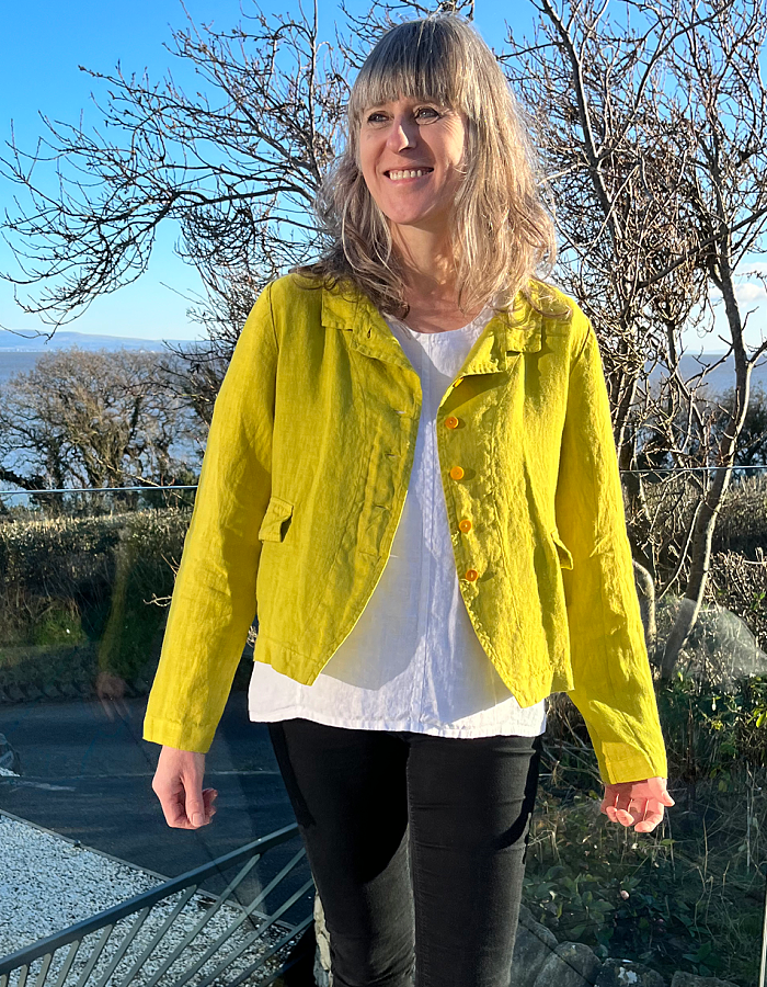 yellow linen summer jacket with 4 buttons at the front and full length sleeves pockets