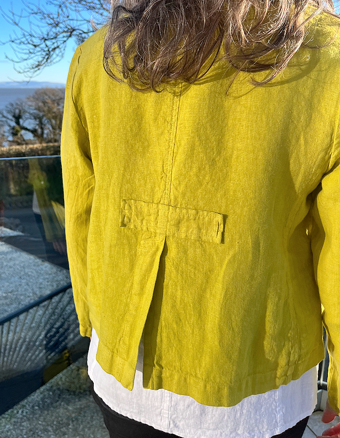 yellow linen summer jacket with 4 buttons at the front and full length sleeves pockets
