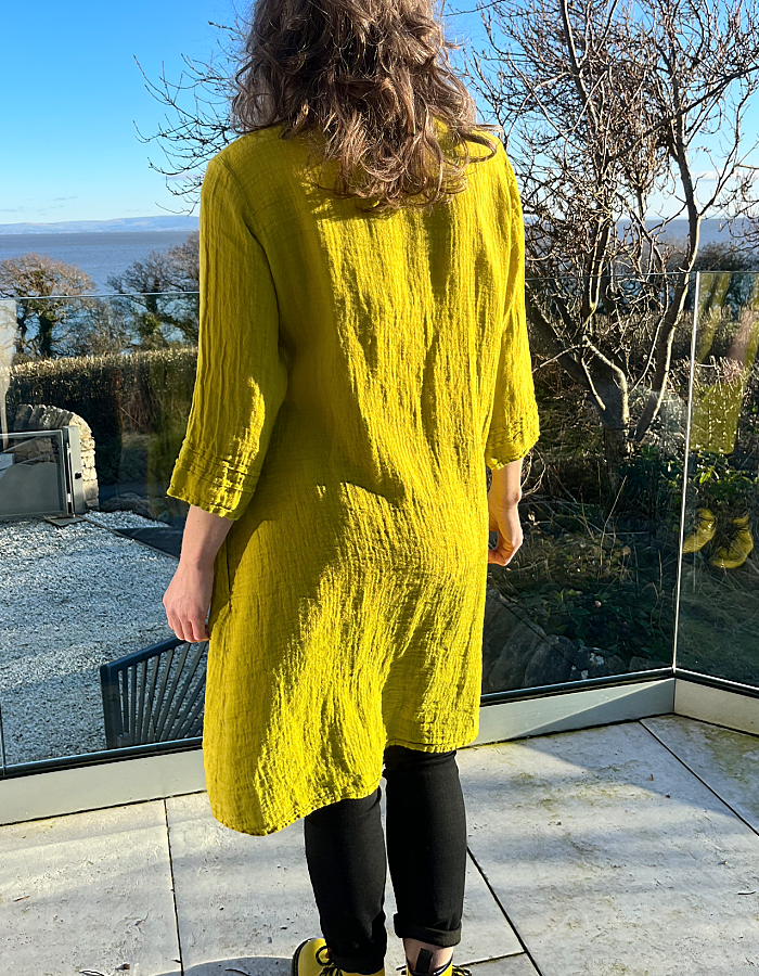 yellow linen loose fit dress with empire line fit and three quarter sleeves and pockets
