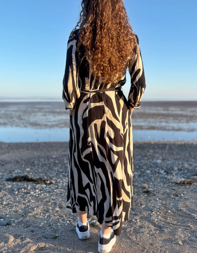 woman wearing zebra print shirt dress