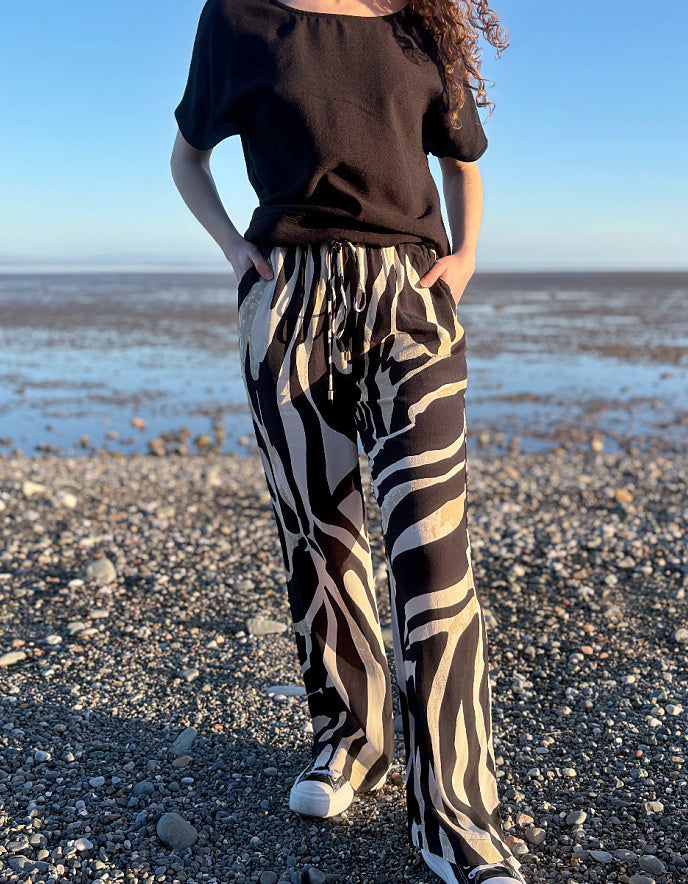 woman wearing zebra print wide leg trousers